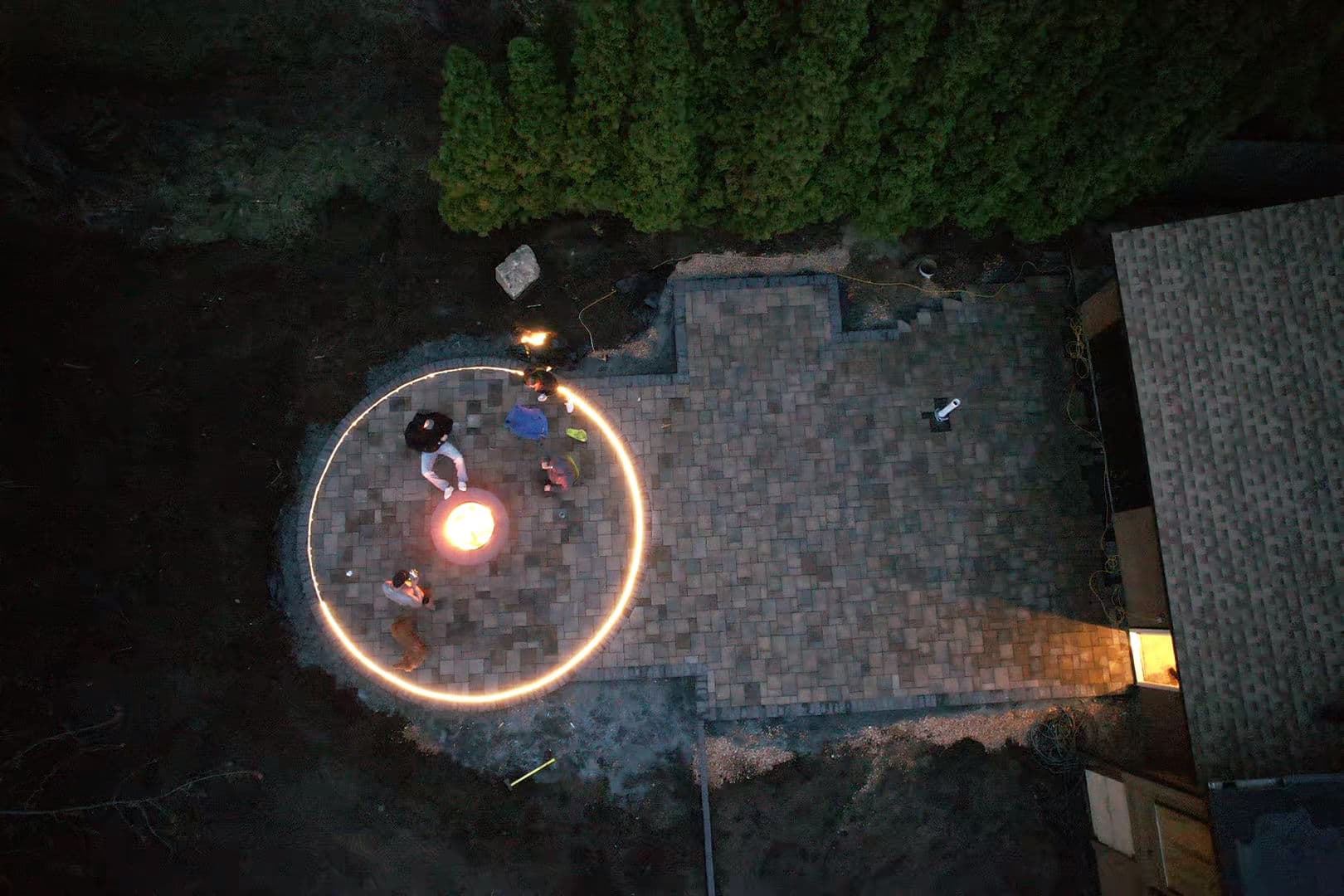 Paver Patio With Fire Pit and Inlaid Lighting That Works Day and Night image